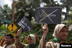 Muslim students hold posters during a protest against Valentine's Day celebrations in Surabaya, Indonesia, Feb. 13, 2017, in this photo taken by Antara Foto.