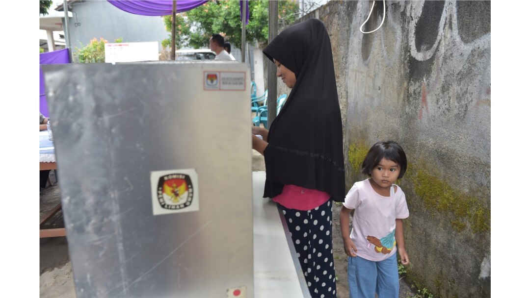 Seorang pemilih sedang melaksanakan hak pilih saat pilkada Tangerang, Banten 27 Juni 2018. (Foto: AFP)