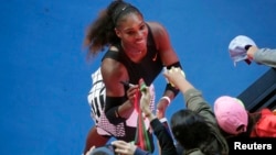 Serena Williams signs autographs after winning her Women's singles semi-final match against Croatia's Mirjana Lucic-Baroni. 