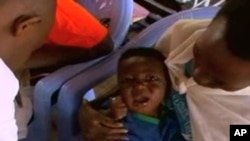 A Rwandan child gets vaccinated at a clinic