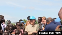 UN Secretary General Ban Ki-moon holds a child as he visits a UN compound in Juba on May 6, 2014, where thousands of displaced persons have sought shelter. The hair of many of the children is beginning to turn red, a sign of malnutrition.