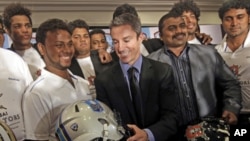 Chief Executive Officer of Elite Football League India Richard Whelan, center, poses with Indian players during a press conference to announce the league in Mumbai, India, Aug. 5, 2011.