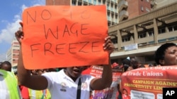 FILE: imbabwean workers demonstrate against the high cost of living and low wages in Harare, Saturday, April, 11, 2015. (AP Photo/Tsvangirayi Mukwazhi)