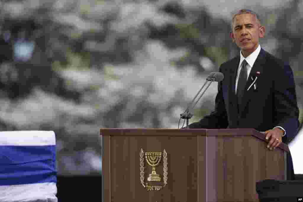 U.S. President Barack Obama speeches next to the flag-draped coffin of former Israeli President Shimon Peres during his funeral at the Mount Herzel national cemetery in Jerusalem, Friday, Sept. 30, 2016.