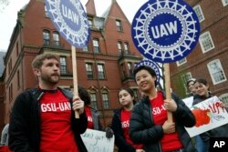 Union protesters march at Harvard University in Cambridge, Mass., May 1, 2019.