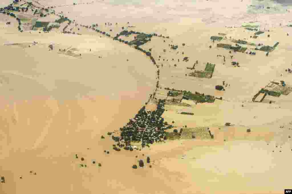 An aerial view shows floodwaters inundating houses and vegetation in Kalay, upper Myanmar's Sagaing region. The toll from flash floods and landslides in Myanmar after days of torrential rain is likely to spike, the U.N. warned as monsoonal downpours brought misery to thousands across the region.