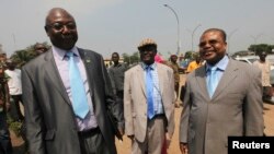 FILE - Martin Ziguele, left, former Central African Republic prime minister, and Nicolas Tiangaye, right, appear at the Bangui airport Jan. 7, 2013. Both are candidates in the next presidential race. 