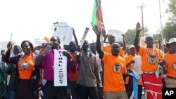 Southern Sudanese citizens clog the streets of the southern capital Juba as they march in support of the upcoming independence referendum, Dec 9, 2010