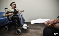 Alexander Gorbunov talks to AFP correspondent during an interview in Moscow, May 3, 2019. Diagnosed with spinal muscular atrophy and using his right index finger to type. StalinGulag has built a nearly 1.5 million army of followers on Twitter and Telegram.