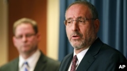 FILE - United States Attorney Andrew Luger, right, and FBI special agent Richard Thornton explain terrorism charges against six men in Minneapolis, April 20, 2015. Defendants such as these will ultimately be released into the society they railed against.