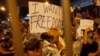 Protesters hold up signs during an evening rally attended by thousands in front of the government headquarters in Hong Kong, Sept. 27, 2014. 