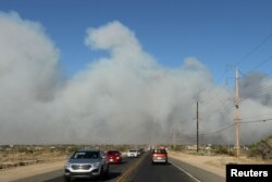 Cars flee the North Fire near Phelan, California, July 17, 2015