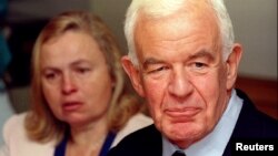 FILE - Tom Foley along and his wife Heather pause at the conclusion of a news conference.