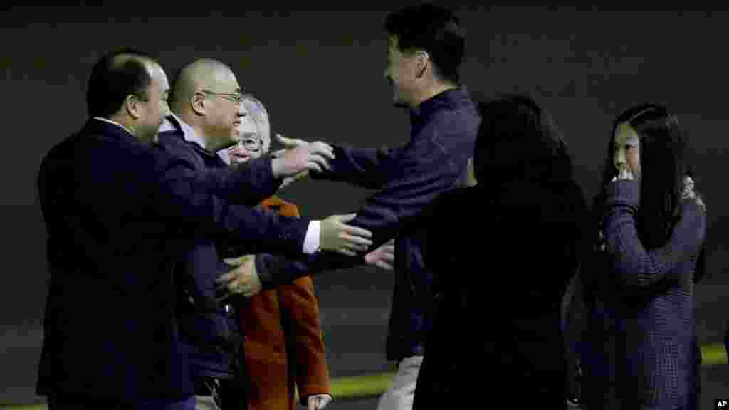 Kenneth Bae, second from left, who had been held in North Korea since 2012, is greeted after arriving at Joint Base Lewis-McChord, Washington, Nov. 8, 2014.