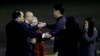 Kenneth Bae, second from left, who had been held in North Korea since 2012, is greeted after arriving at Joint Base Lewis-McChord, Washington, Nov. 8, 2014.