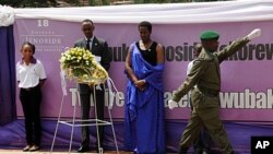 Rwandan President Paul Kagame (2nd from Left) and Rwandan First Lady, Jeanette Kagame, lay a wreath at the Genocide Memorial in Kigali on April 7, 2012.