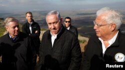 Israeli Prime Minister Benjamin Netanyahu, U.S. Republican Senator Lindsey Graham and U.S. Ambassador to Israel David Friedman visit the border line between Israel and Syria at the Israeli-occupied Golan Heights, March 11, 2019. 