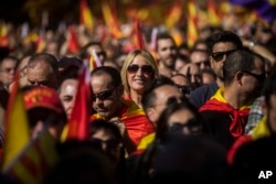 Activists march during a mass rally against Catalonia's declaration of independence, in Barcelona, Spain, Oct. 29, 2017.