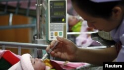 Two-hour old daughter of a 17-year old girl is fed by a nurse at a hospital in Chiang Mai's Fang district.