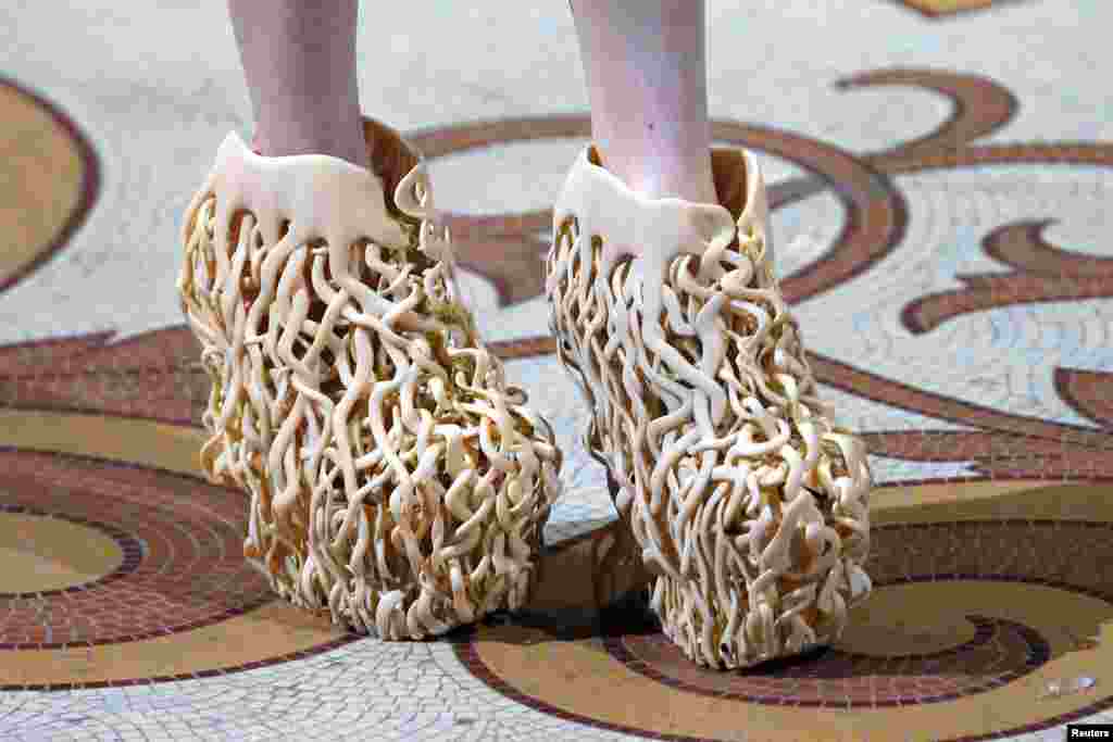 A model presents shoes created by designer Iris van Herpen as part of the Haute Couture Fall Winter 2013/2014 fashion show in Paris, France.