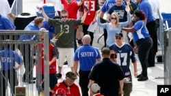 Football fans are screened by security as they enter Raymond James Stadium before the start of an NFL football game between the Tampa Bay Buccaneers and the Dallas Cowboys, Nov. 15, 2015, in Tampa, Fla. 