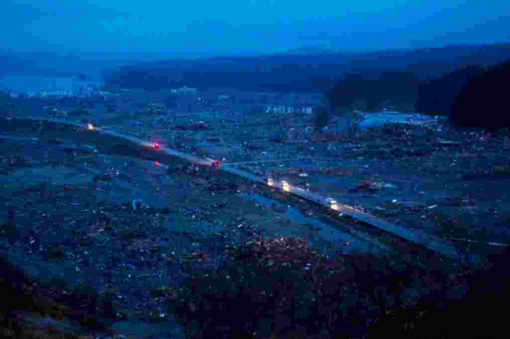 Japanese vehicles pass through the ruins of the leveled city of Minamisanriku, northeastern Japan, Tuesday March 15. (AP)