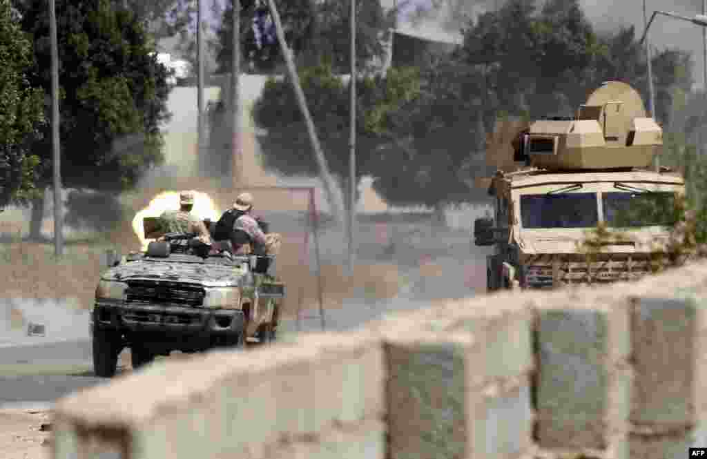 Fighters loyal to the internationally-recognized Government of National Accord (GNA) fire a jeep-mounted gun during clashes with forces loyal to Khalifa Haftar, leader of the dissident Libyan National Army, in Espiaa, about 40 kilometres south of the Libyan capital, Tripoli.