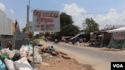 A sign advertising scraps for sale from businessman Mao Tran hangs on a wire in the outskirt of Phnom Penh, Cambodia, April 22, 2020. (Phorn Bopha /VOA Khmer) 