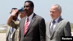 The United Nations envoy for Somalia, Nicholas Kay (R), is welcomed by Somalia's Information Minister Abdullahi Ilmoge at the airport in Somalia's capital Mogadishu, June 2013.