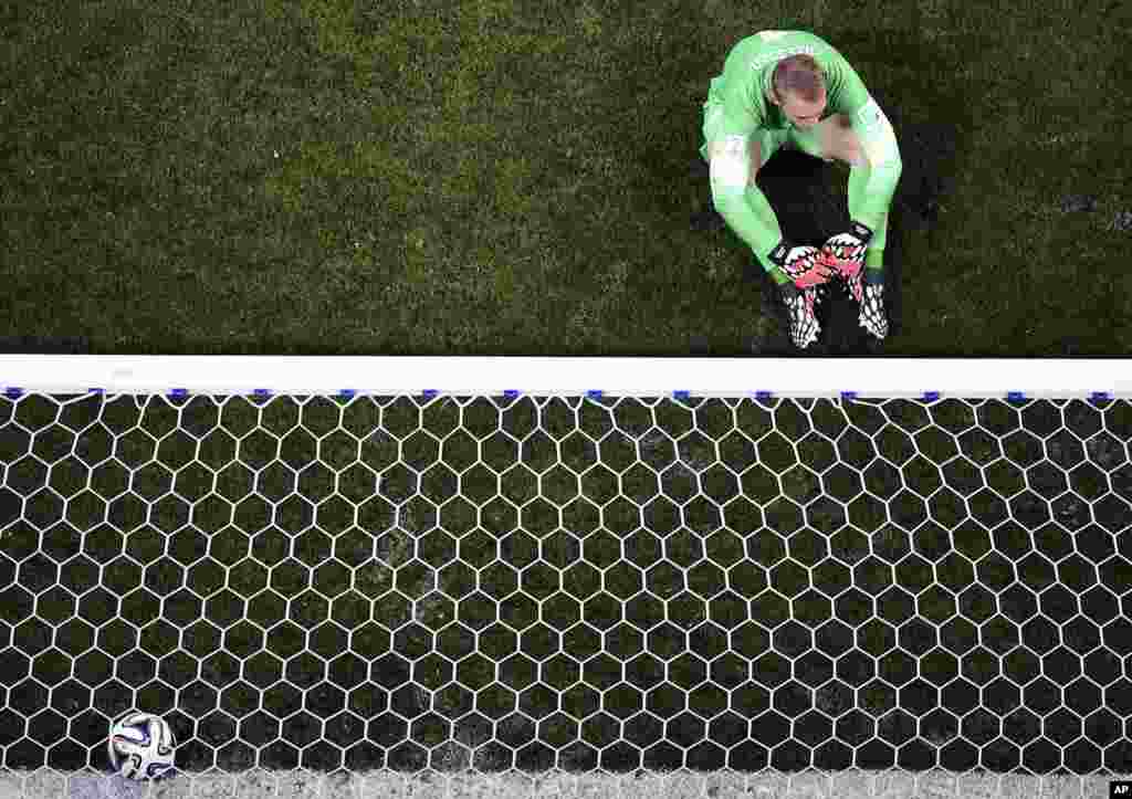 Netherlands' goalkeeper Jasper Cillessen sits on the pitch after Argentina's Maxi Rodriguez scored the decisive penalty kick during the World Cup semifinal soccer match at the Itaquerao Stadium in Sao Paulo, Brazil, July 9, 2014.