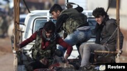 FILE - Free Syrian Army fighters ride on a pick-up truck with a fellow fighter, who was injured during an offensive, on the outskirts of the northern Syrian town of al-Bab, Jan. 10, 2017. The FSA now faces a supply cut-off of the few arms the U.S. did provide for the group.