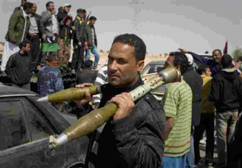 A rebel carries Rocket Propelled Grenades (RPG) after taking Ajdabiya, south of Benghazi, eastern Libya, March 26, 2011