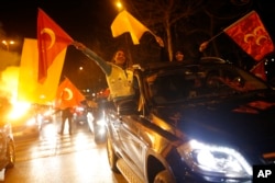 Supporters of President Recep Tayyip Erdogan celebrate in Istanbul, early Monday, April 1, 2019. Erdogan's ruling party has declared victory in the race for mayor of Istanbul, even though the result in Turkey's most populous city and commercial hub is too close to call.