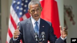 President Barack Obama speaks about recent unrest in Baltimore during his joint news conference with Japanese Prime Minister Shinzo Abe, April 28, 2015, in the Rose Garden of the White House in Washington. 