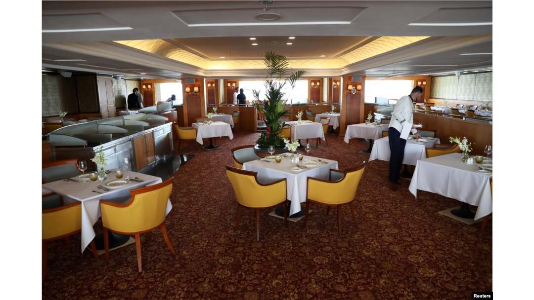 A worker is seen inside the restaurant of the Queen Elizabeth II cruise ship, launched as a hotel, in Dubai, UAE, April 18, 2018.