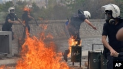 Riot police run from fire bombs thrown by protesters as they blame ruling AK Party government for mining disaster in western Turkey, Ankara, May 14, 2014.