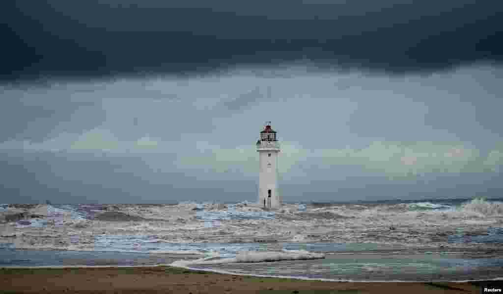 Storm clouds gather above Perch Rock lighthouse in New Brighton, northern England.