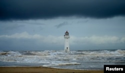 FILE - Storm clouds gather above Perch Rock lighthouse in New Brighton, northern England, Nov. 16, 2016. (REUTERS/Phil Noble)