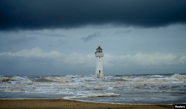 FILE - Storm clouds gather above Perch Rock lighthouse in New Brighton, northern England, Nov. 16, 2016. (REUTERS/Phil Noble)