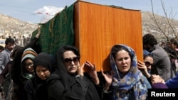 Para aktivis hak perempuan Afghanistan memanggul peti jenazah Farkhunda, perempuan Afghanistan yang dipukul dan dibakar sampai mati pada 19 Maret, dalam pemakamannya di Kabul (22/3). (Reuters/Mohammad Ismail)