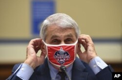 Dr. Anthony Fauci, director of the National Institute for Allergy and Infectious Diseases, adjusts his face mask during a House Subcommittee on the Coronavirus crisis hearing, Friday, July 31, 2020 on Capitol Hill in Washington.