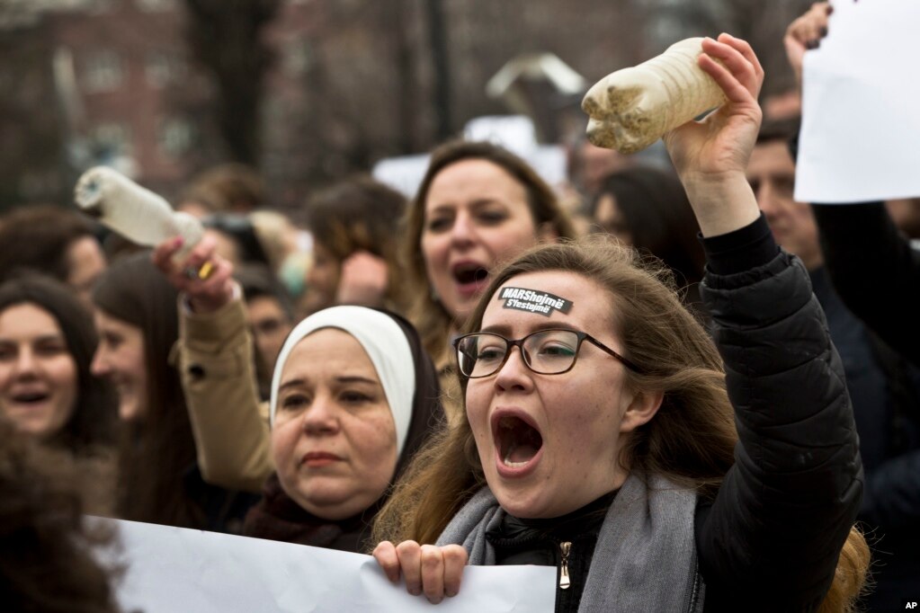 Kosovo feminist with a sticker on her forehead reading &quot;We March we don&#39;t celebrate&quot; march on the occasion of the International Women&#39;s Day in Pristina, Kosovo, March 8, 2017. Kosovo feminists advocate for gender equality and protest against violence against women.