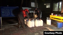 太平岛上驻岛人员给渔民带来的水桶内装“太平水”(台湾海巡署提供)