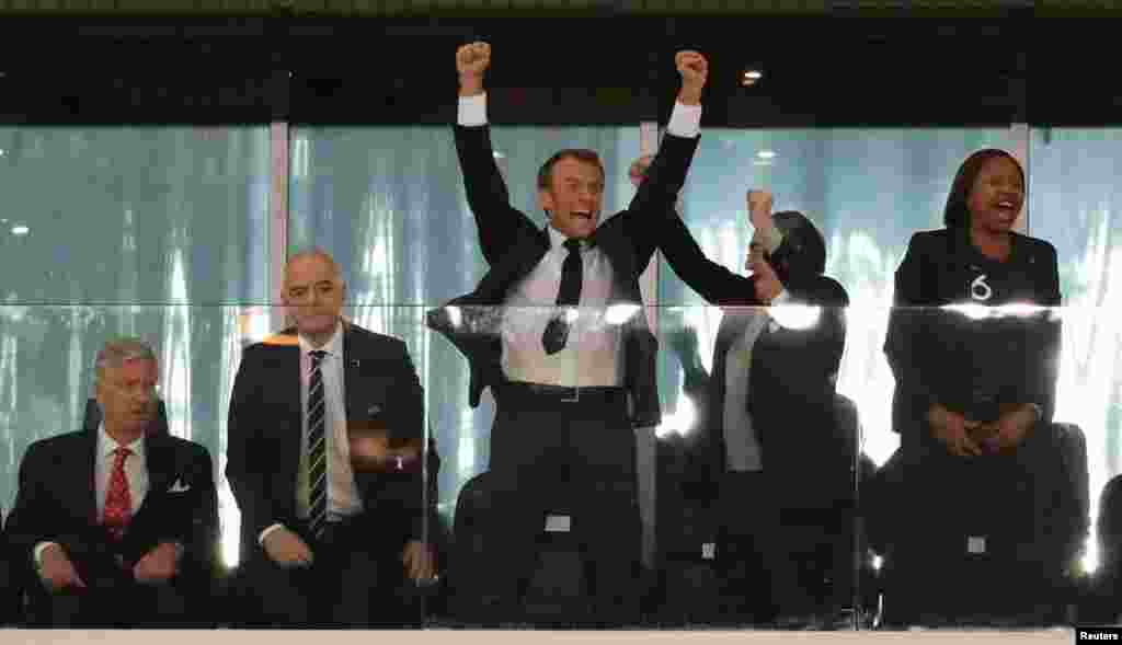 French President Emmanuel Macron (C) celebrates France&#39;s victory over Belgium during the semifinal match between the two teams at the 2018 soccer World Cup at the St. Petersburg Stadium in St. Petersburg, Russia, as King Philippe of Belgium (L) looks on, July 10, 2018.