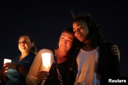People attend a candlelight vigil for victims of the Route 91 music festival mass shooting next to the Mandalay Bay Resort and Casino in Las Vegas, Nevada, Oct. 3, 2017.