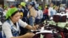 FILE - Cambodians work inside a factory in Phnom Penh, May 10, 2004 photo. 