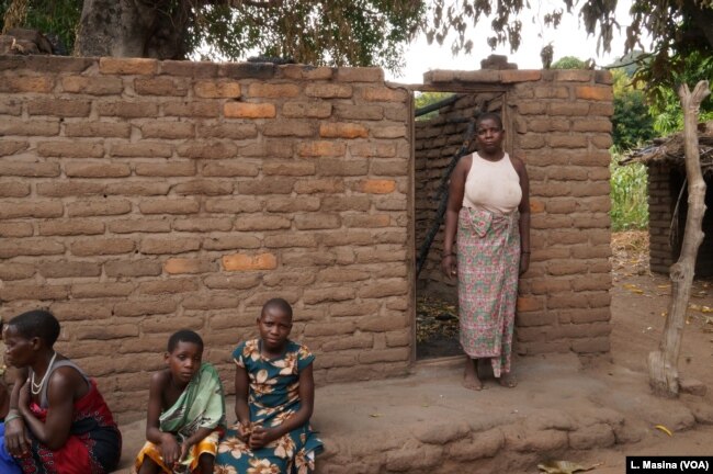 Aidah Waisoni standing outside his burnt house in Phalombe district.