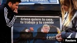 A poster depicts U.S. District Court Judge Thomas Griesa, overseeing a case in which U.S. hedge funds are suing Argentina, as a vulture in Buenos Aires, Aug. 12, 2014.