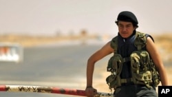 A Libyan rebel stands near the entrance of Ras Lanuf oil refinery August 27, 2011