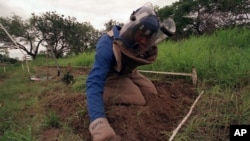 FILE - A former rebel soldier clears land mines in Hnadane, 62 miles south of Maputo, Mozambique.